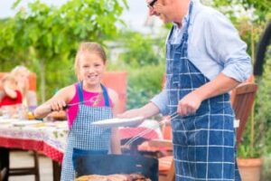 a-girl-helping-her-dad-with-the-griller