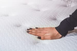 woman's hand on memory foam mattress