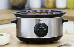 cooking appliance and bowl of rice on table