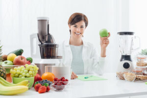 woman with a juicer and a blender