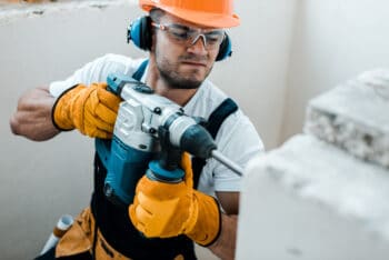 a man drilling a wall