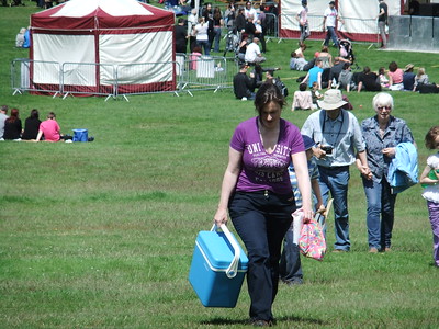 a woman carrying a blue container