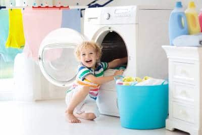 child in a laundry room